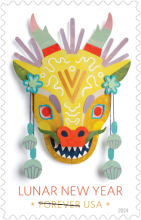 Centered on a stamp is a face of a dragon colored light gold, with twelve jagged white teeth, an orange nose, red eyes, tri-color horns with pink at the tip, light green in the middle, and red at the base. The stamp reads, "Lunar New Year USA" with a strikethrough the word "Forever". The year 2024 is noted at the bottom-right corner of the stamp.