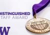 A bronze medal with the words University of Washington 1861 engraved on it and a purple ribbon attached to it sits atop a white background with the capital letter W in the lower left-hand corner and the words Distinguished Staff Award off to the left