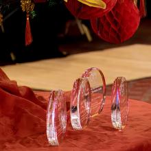 Four glass awards noted as Golden Circle Award sit atop a table decorated with a red tablecloth